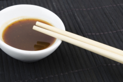 Hoisin__Chopsticks_-_Bowl_of_asian_dipping_sauce_on_a_black_mat_xs.jpg